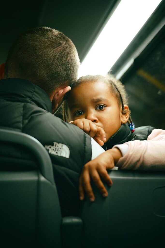 Young child looking concerned on a bus